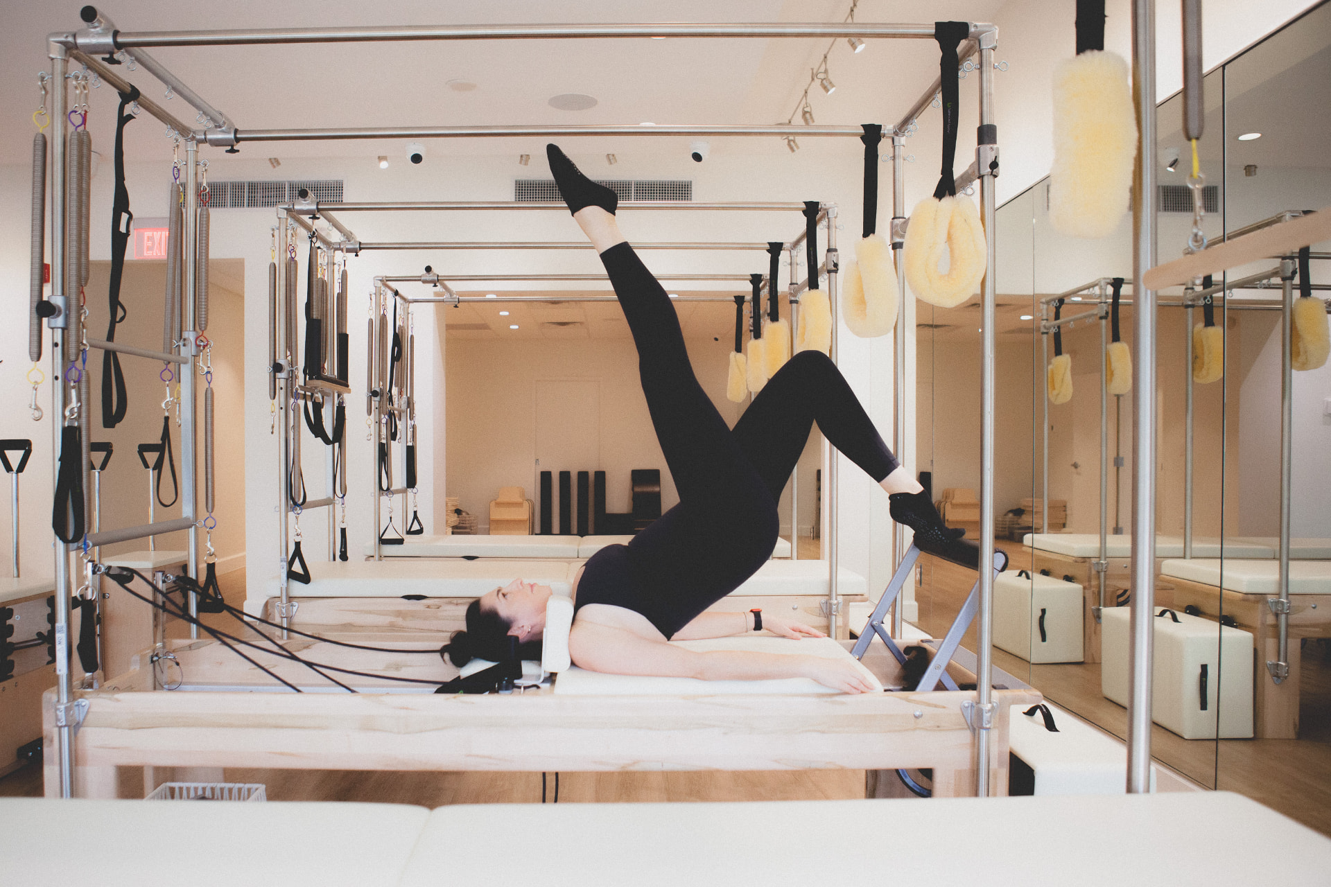 Home Pilates practice with a laptop for online classes